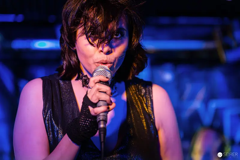 Nightmarcher Performing Intense Vocal Set at Replugged Vienna with Dramatic Blue Lighting