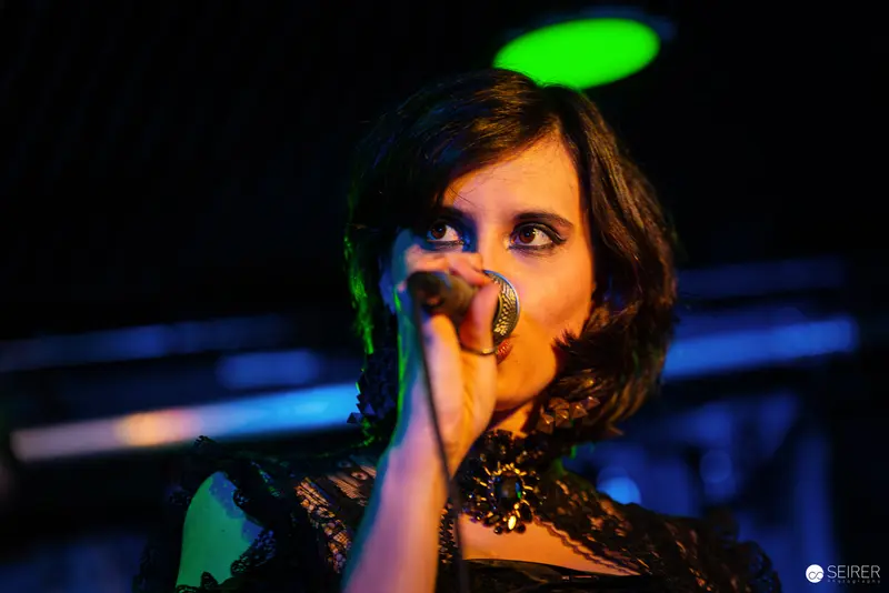 Nightmarcher Performing at Replugged Vienna with Dramatic Green and Blue Stage Lighting