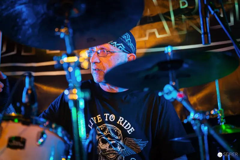 Nightmarcher Drummer Performing Under Intense Blue Stage Lighting at Replugged Vienna