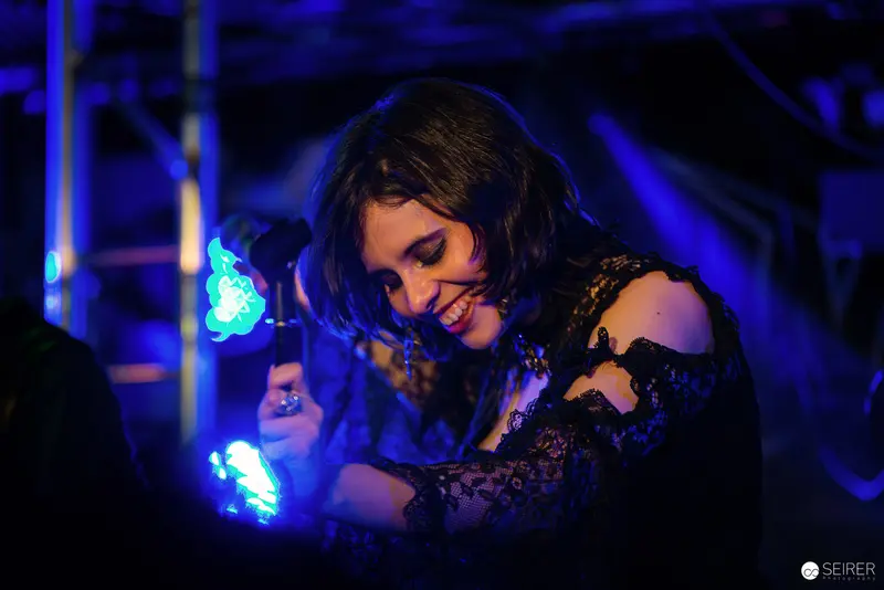 Nightmarcher Performing at Replugged Vienna Under Vibrant Blue Stage Lighting