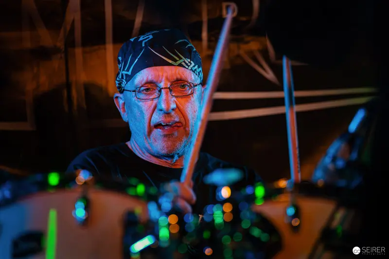 Nightmarcher Drummer at Replugged Vienna in Intense Blue and Green Stage Lighting