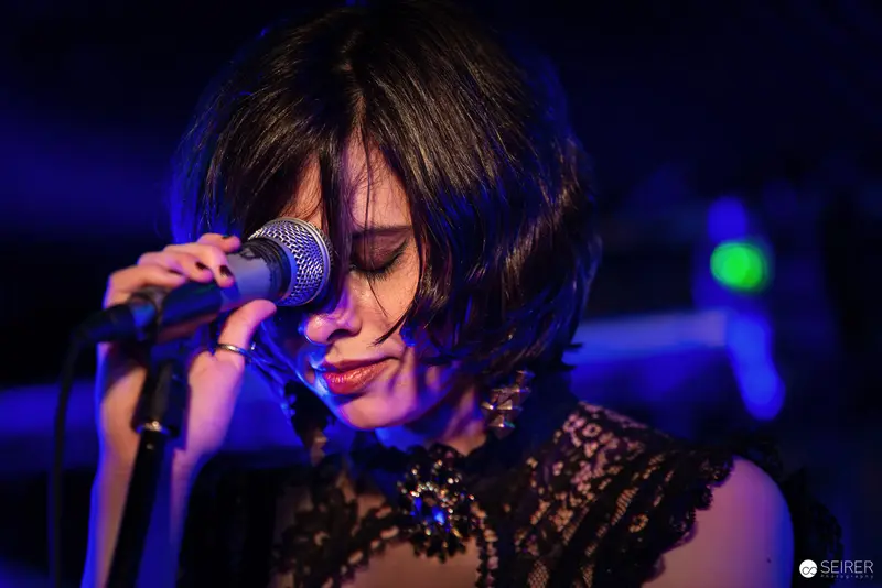 Nightmarcher Performing Intense Vocal Set at Replugged Vienna with Dramatic Blue Lighting