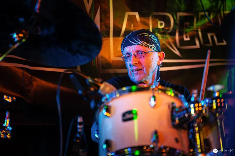 Nightmarcher Drummer Performing at Replugged Vienna Under Colorful Stage Lighting