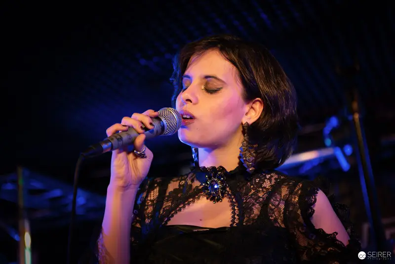 Nightmarcher Performing Intense Vocal Set at Replugged Vienna with Dramatic Lighting