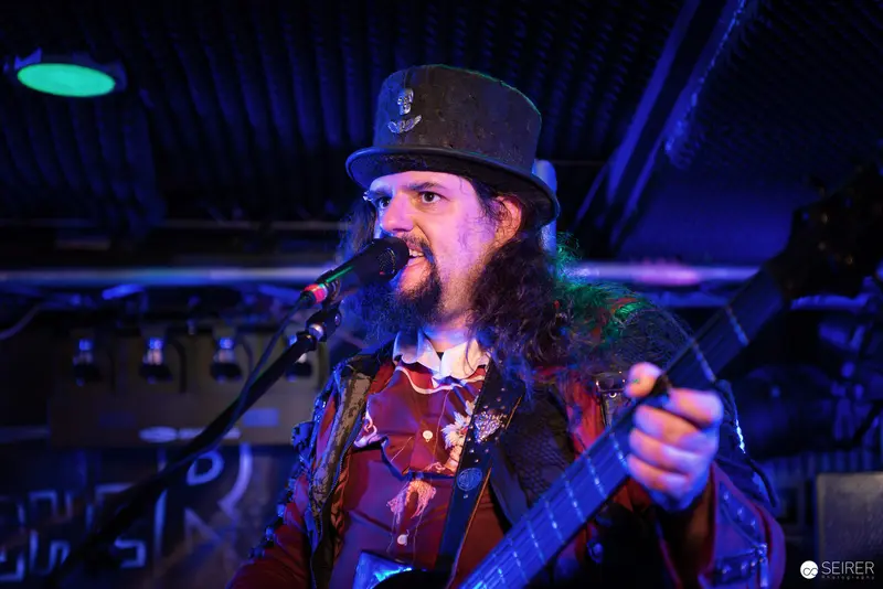 Nightmarcher Performing Passionately at Replugged Vienna with Intense Blue Stage Lighting