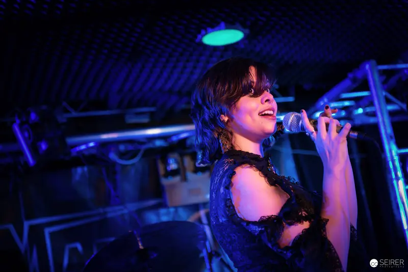 Nightmarcher Performing Intense Vocal Set at Replugged Vienna Under Blue Stage Lighting