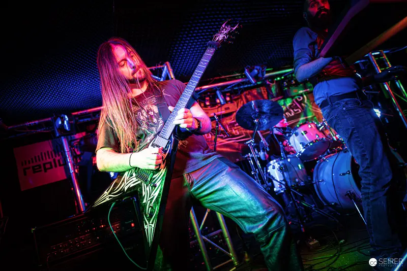 Nightmarcher Guitarist Performing with Intense Energy at Replugged Vienna