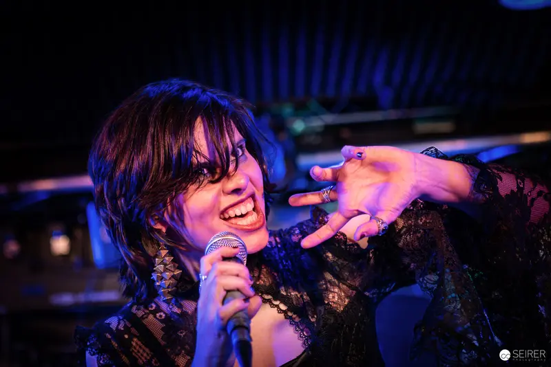 Nightmarcher Performing Passionately at Replugged Vienna with Energetic Microphone Gesture