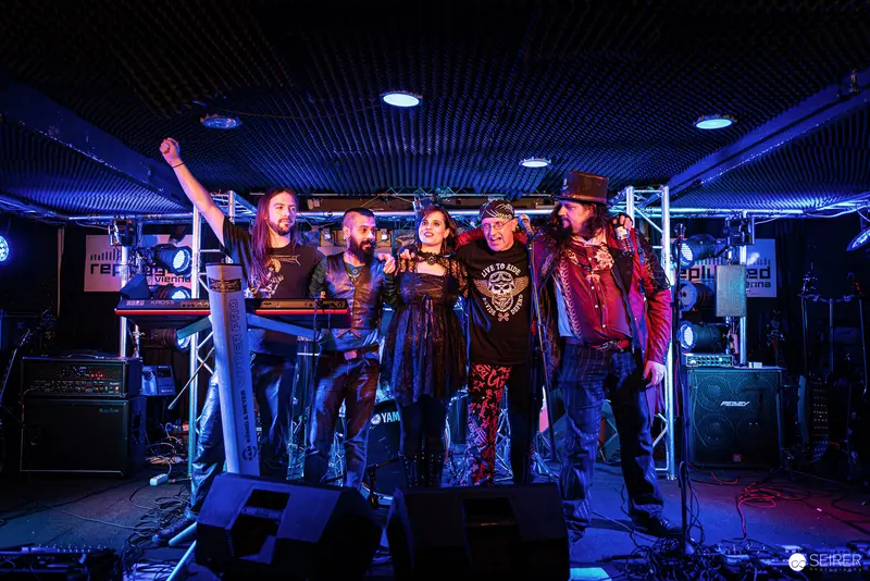 Nightmarcher Band at Replugged Vienna: Dynamic Stage Presence Under Blue Lighting
