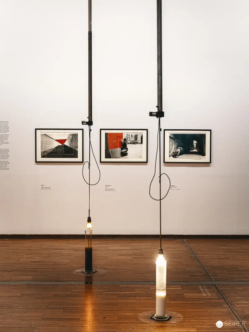 Suspended Photographic Presentation with Illuminated Candles at Art Exhibition