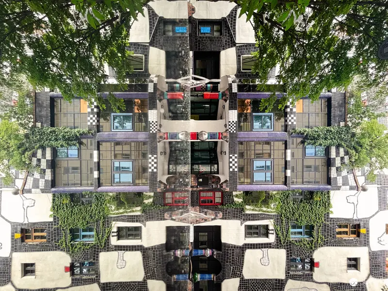 Symmetrical Urban Architecture with Mirrored Facade and Verdant Organic Elements
