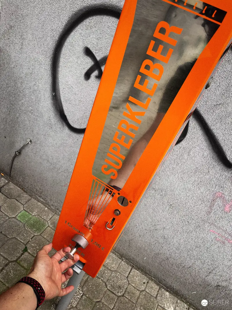 Urban Street Scene with Orange Signage and Graffiti Wall Interaction