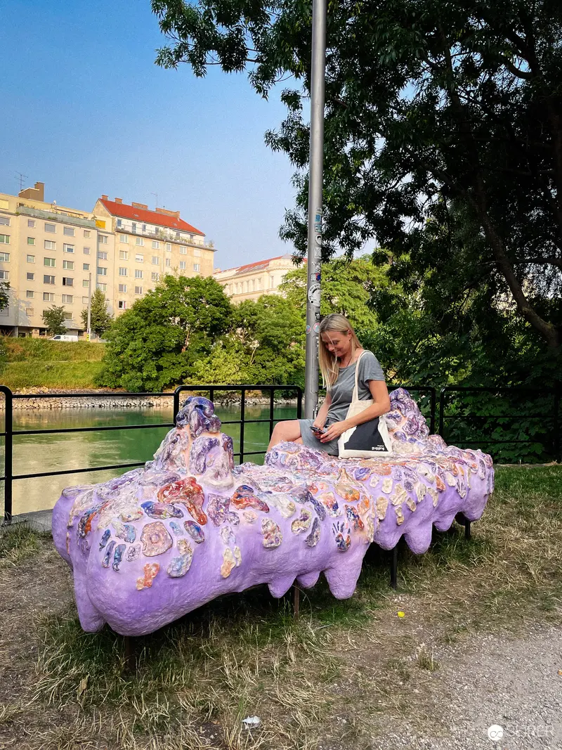 Lavender Caterpillar Installation by Water in Urban Public Space