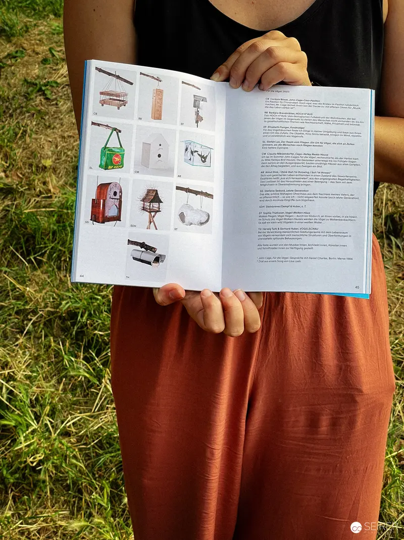 Open Book Displaying Design Sketches and Diagrams on Grassy Outdoor Background