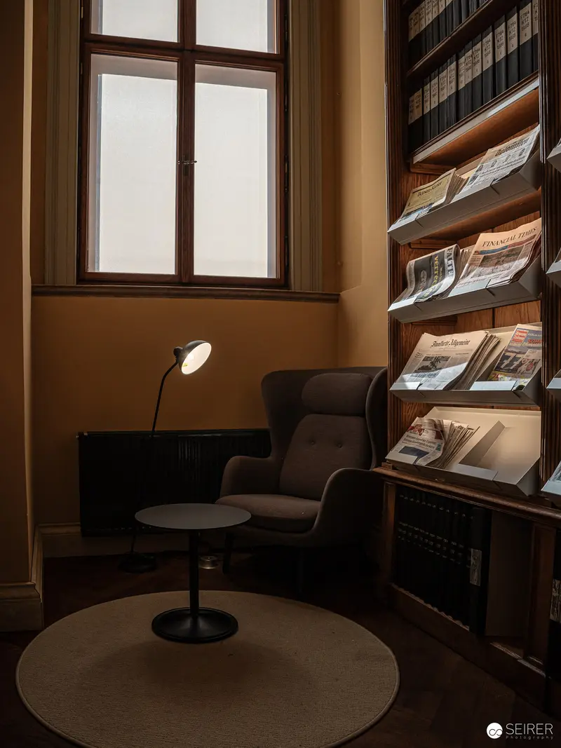 Intimate Reading Nook with Vintage Periodicals and Soft Illumination