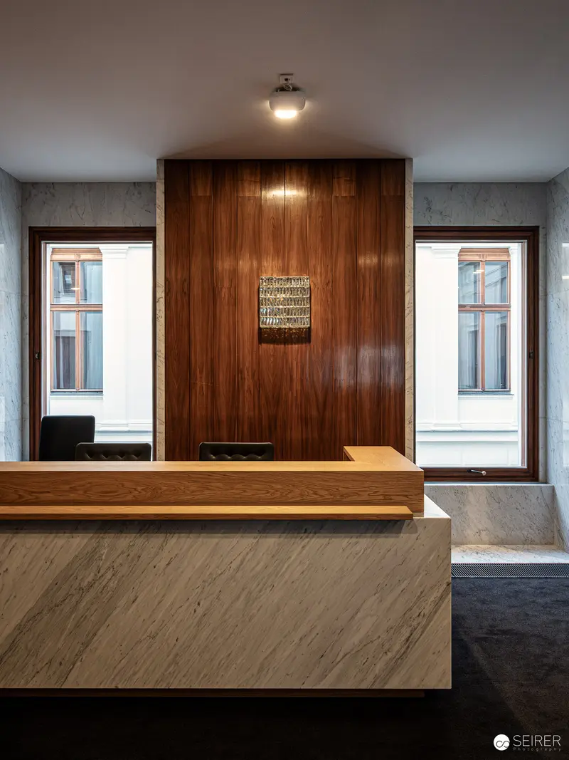 Minimalist Reception Area with Wood Paneling and Marble Desk in Parliamentary Building