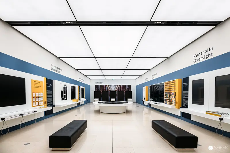 Modernist Interior of Control Room with Geometric Ceiling and Black Benches