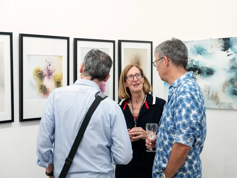 Gallery Conversation: Art Exhibition Attendees Discussing Contemporary Artworks