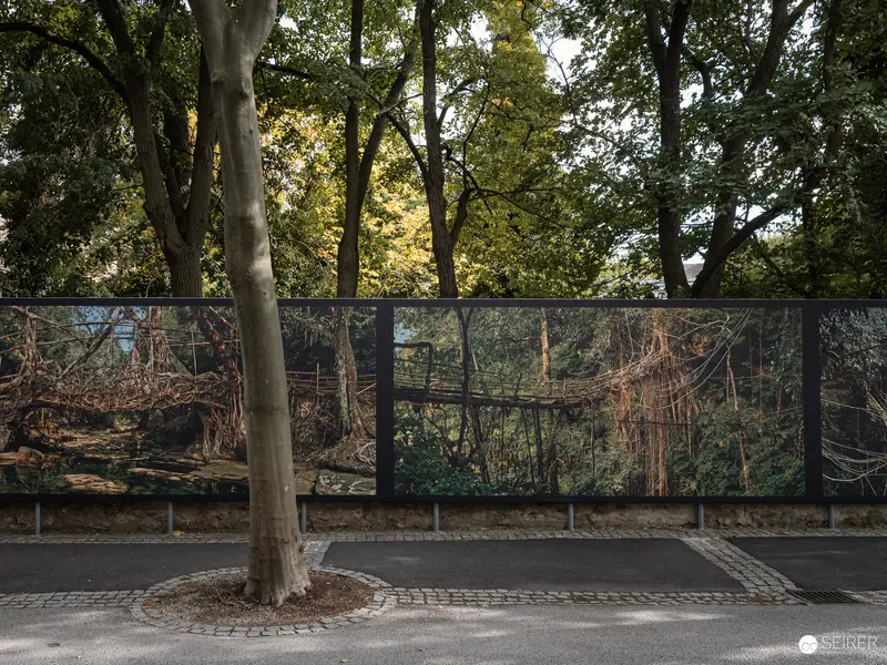Photographic Landscape Panels Depicting Dense Forest Behind Urban Barrier Wall