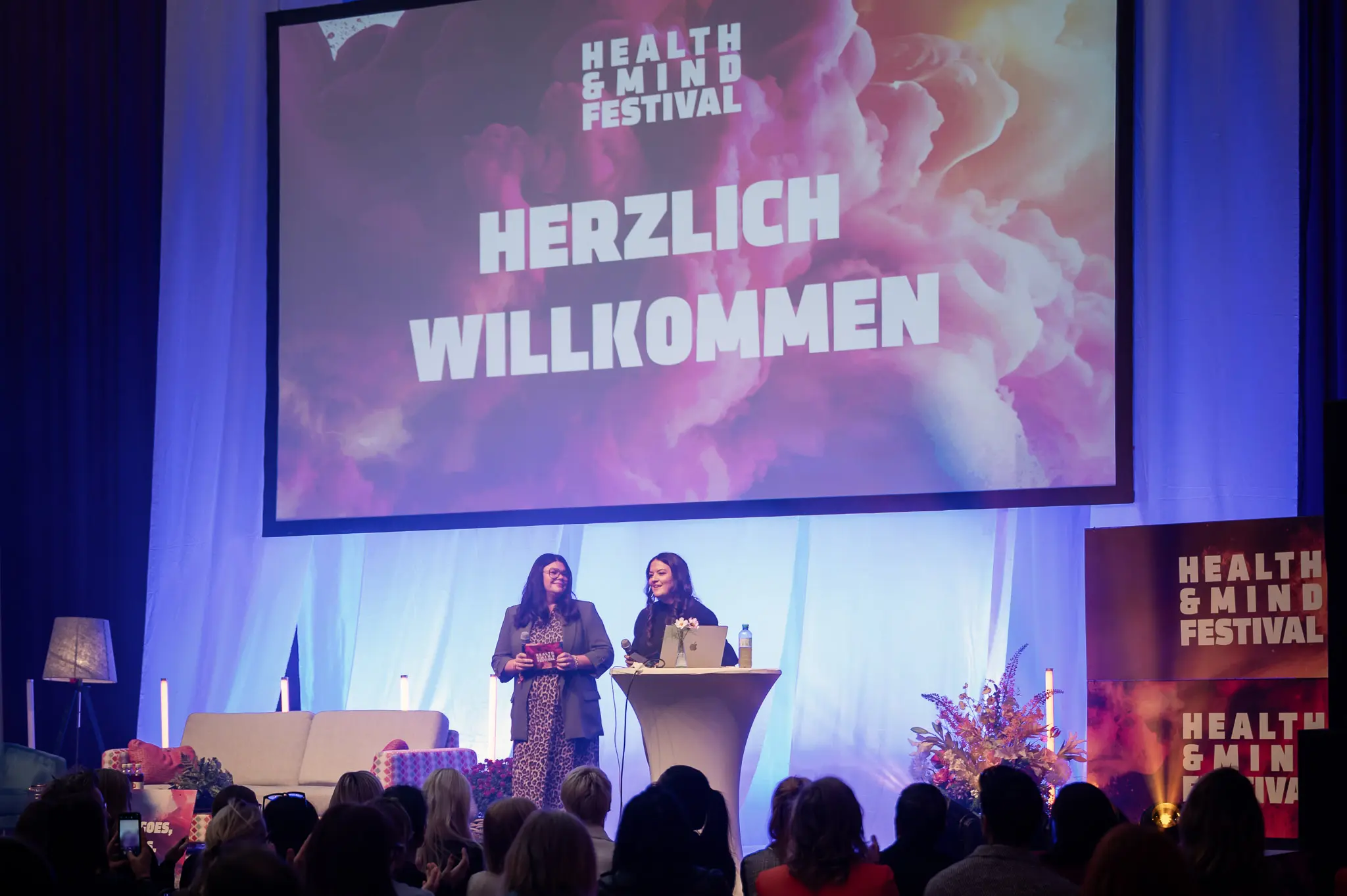 Health & Mind Festival Welcome Presentation with Two Speakers on Stage
