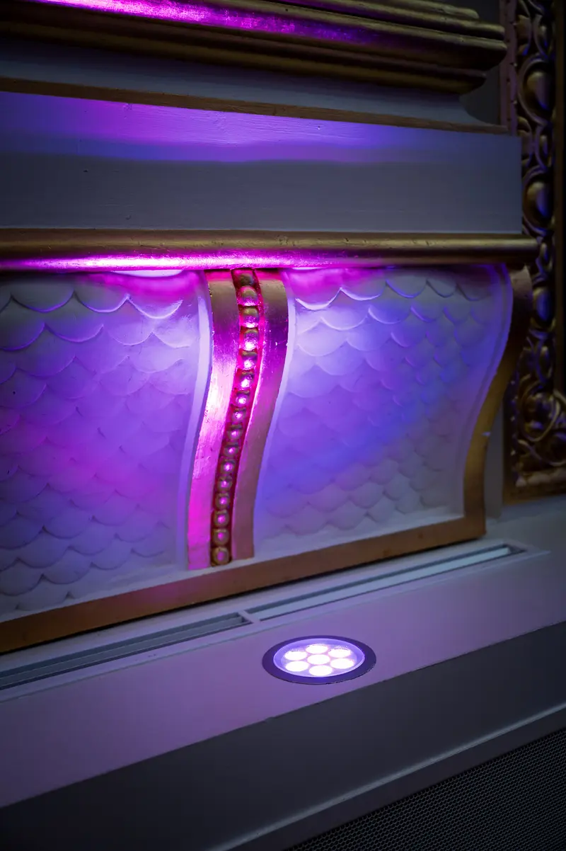 Illuminated Purple Linear Installation with Curved Architectural Lighting Design