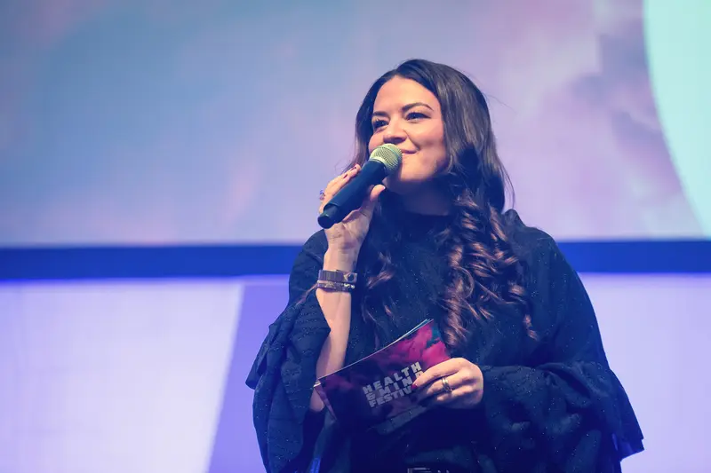 Health & Mind Festival Speaker Delivers Passionate Address with Microphone