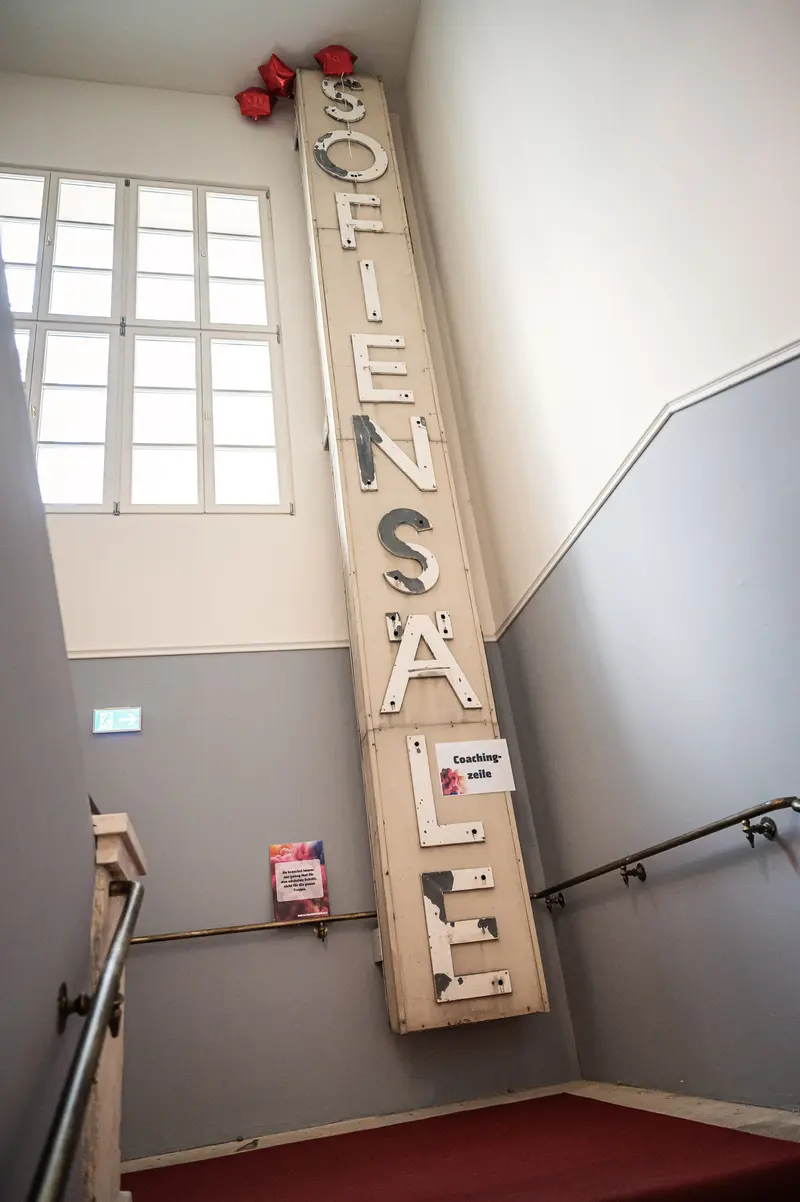 Vertical "OFFENSIVE SALE" Signage in Minimalist Institutional Stairwell