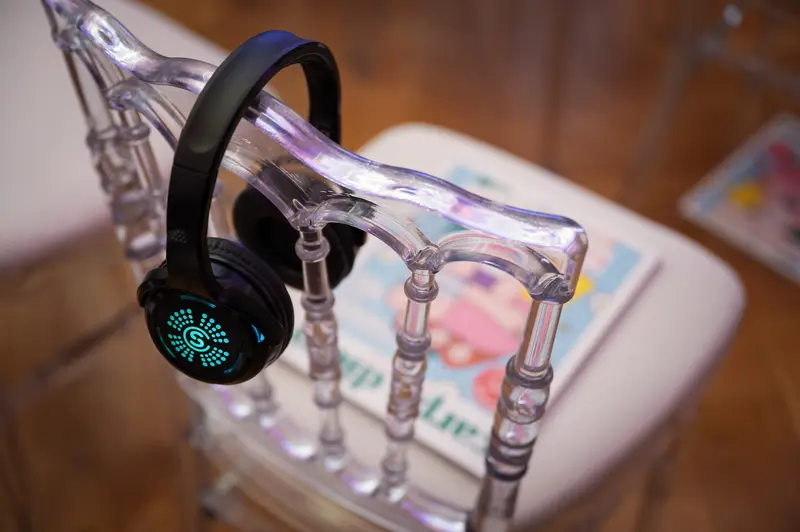 Wireless Headphone Resting on Transparent Sculptural Stand at Health & Mind Festival