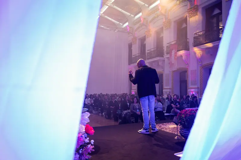 Health & Mind Festival Speaker Addresses Audience in Dramatic Stage Lighting