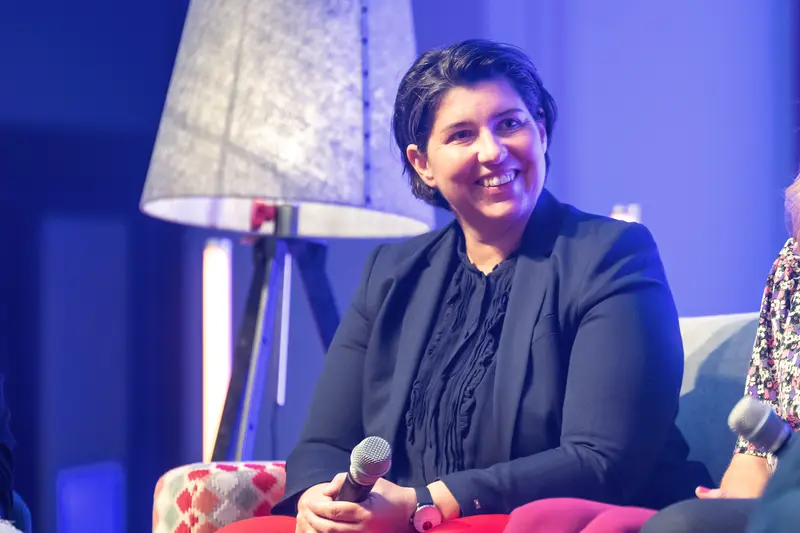 Health & Mind Festival Panelist Smiling on Stage During Engaging Panel Discussion