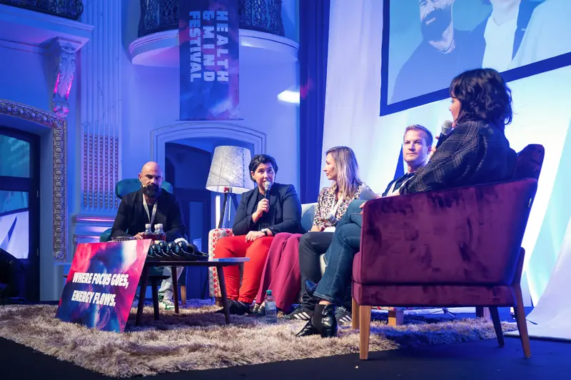 Health & Mind Festival Panel Discussion on Stage with Blue Lighting