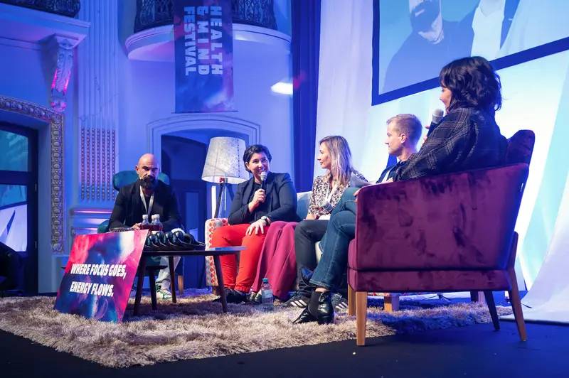 Health & Mind Festival Panel Discussion Under Blue Atmospheric Lighting