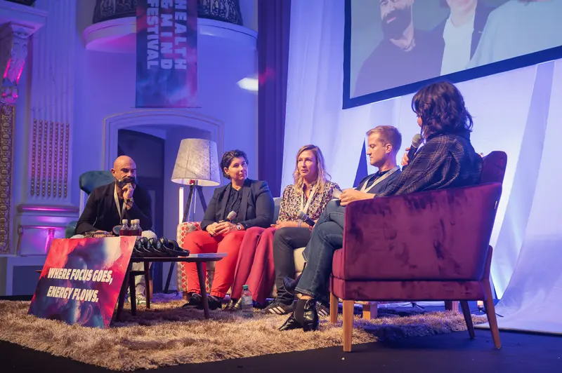 Health & Mind Festival Panel Discussion on Stage with Diverse Speakers
