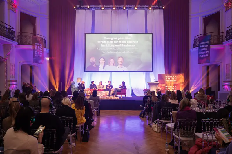 Health & Mind Festival Panel Discussion Under Purple Theatrical Lighting