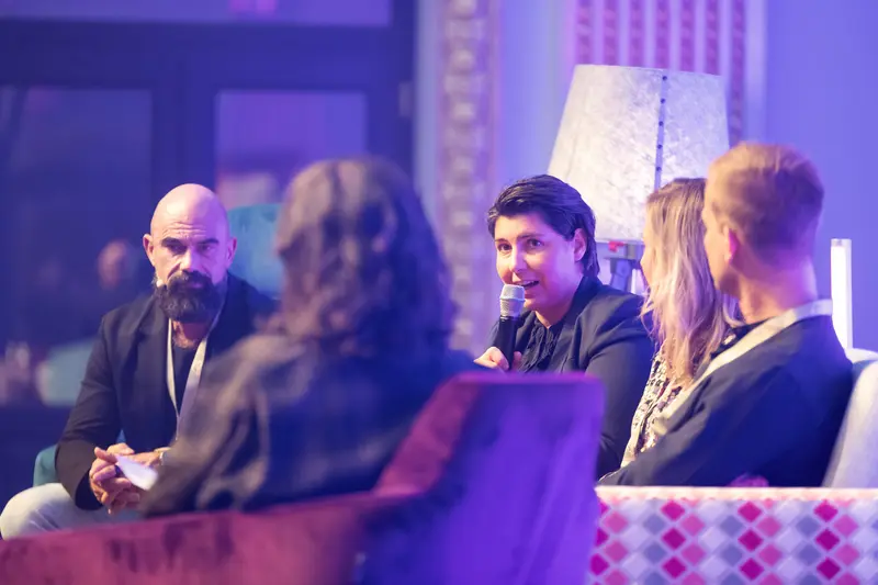 Health & Mind Festival Panel Discussion in Purple-Toned Stage Setting