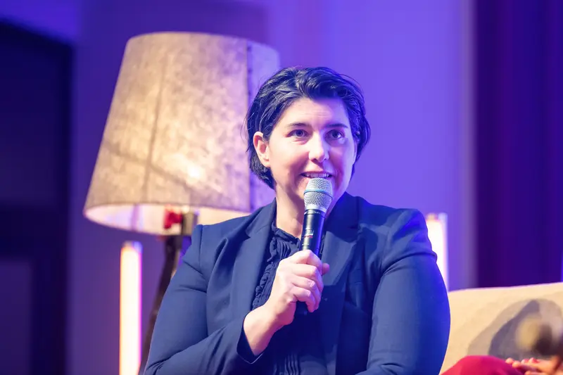 Health & Mind Festival Speaker Delivers Engaging Presentation with Microphone