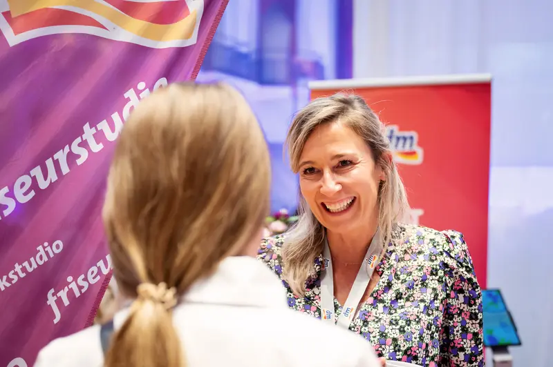 Smiling Professional at Health & Mind Festival Networking Event
