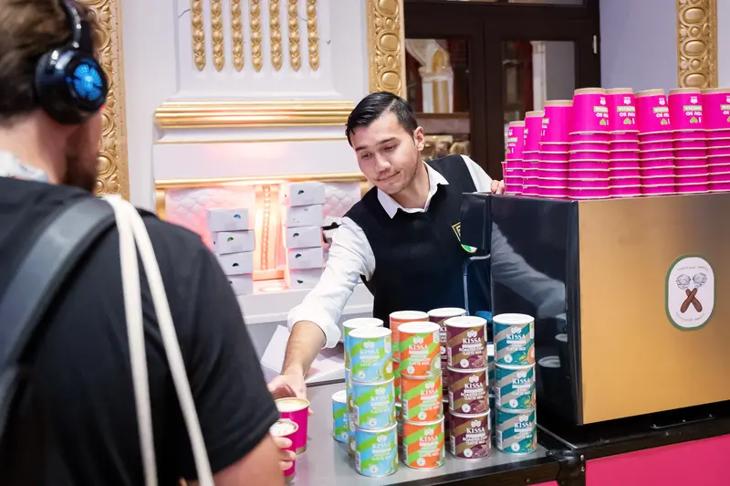 Health & Mind Festival Staff Member Serving Colorful Beverage Cups