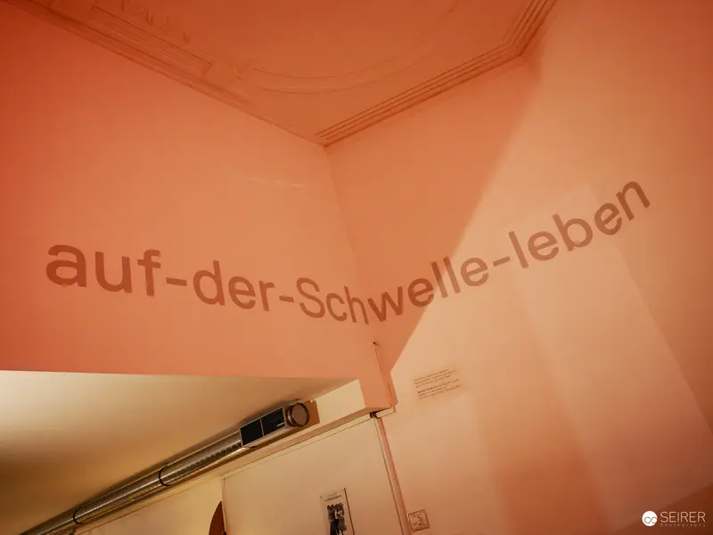 Architectural Text Composition in Warm Terracotta Tones at Nestroyhof Hamakom