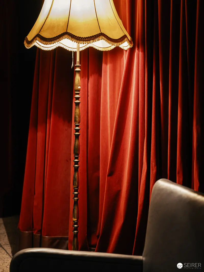Vintage Lamp and Red Curtain in Theatrical Stage Setting