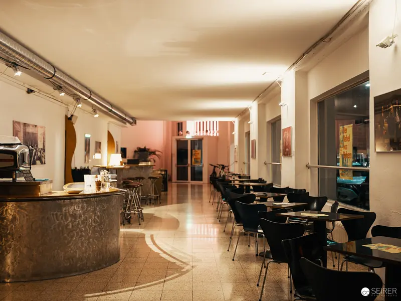 Minimalist Cafe Interior with Curved Bar and Modern Seating Arrangement