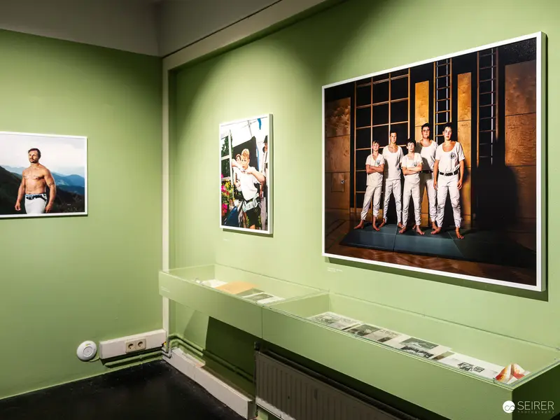 Exhibition View of Photographic Portraits in Green Gallery Space