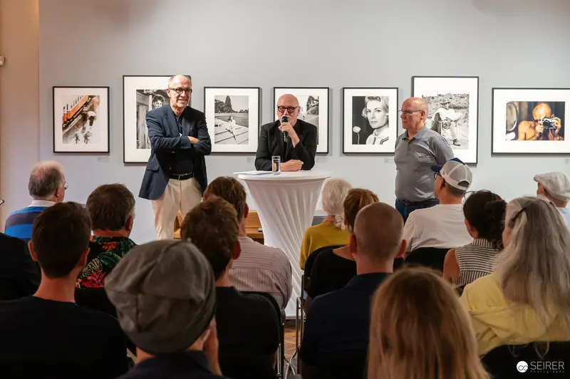 Art Gallery Panel Discussion with Photographers Discussing Framed Photographic Works