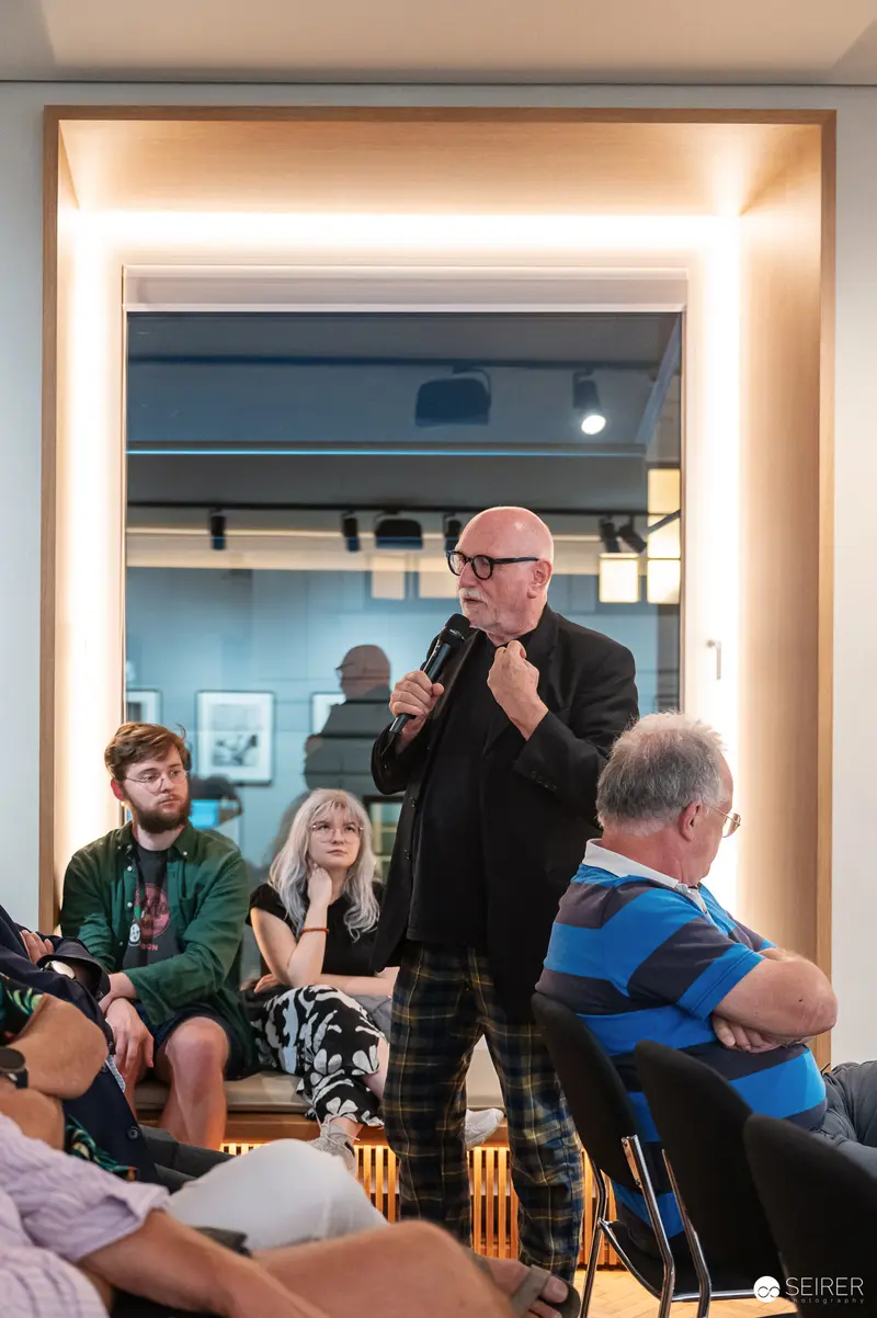 Public Speaking Moment at Indoor Community Event with Diverse Audience