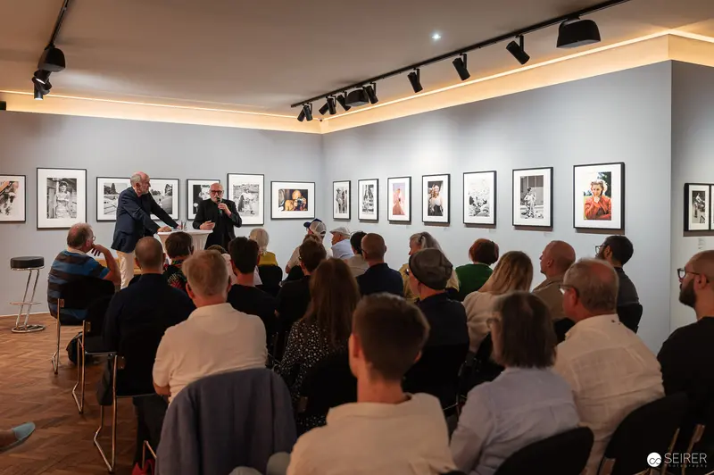 Photography Gallery Talk with Audience and Framed Black and White Artworks