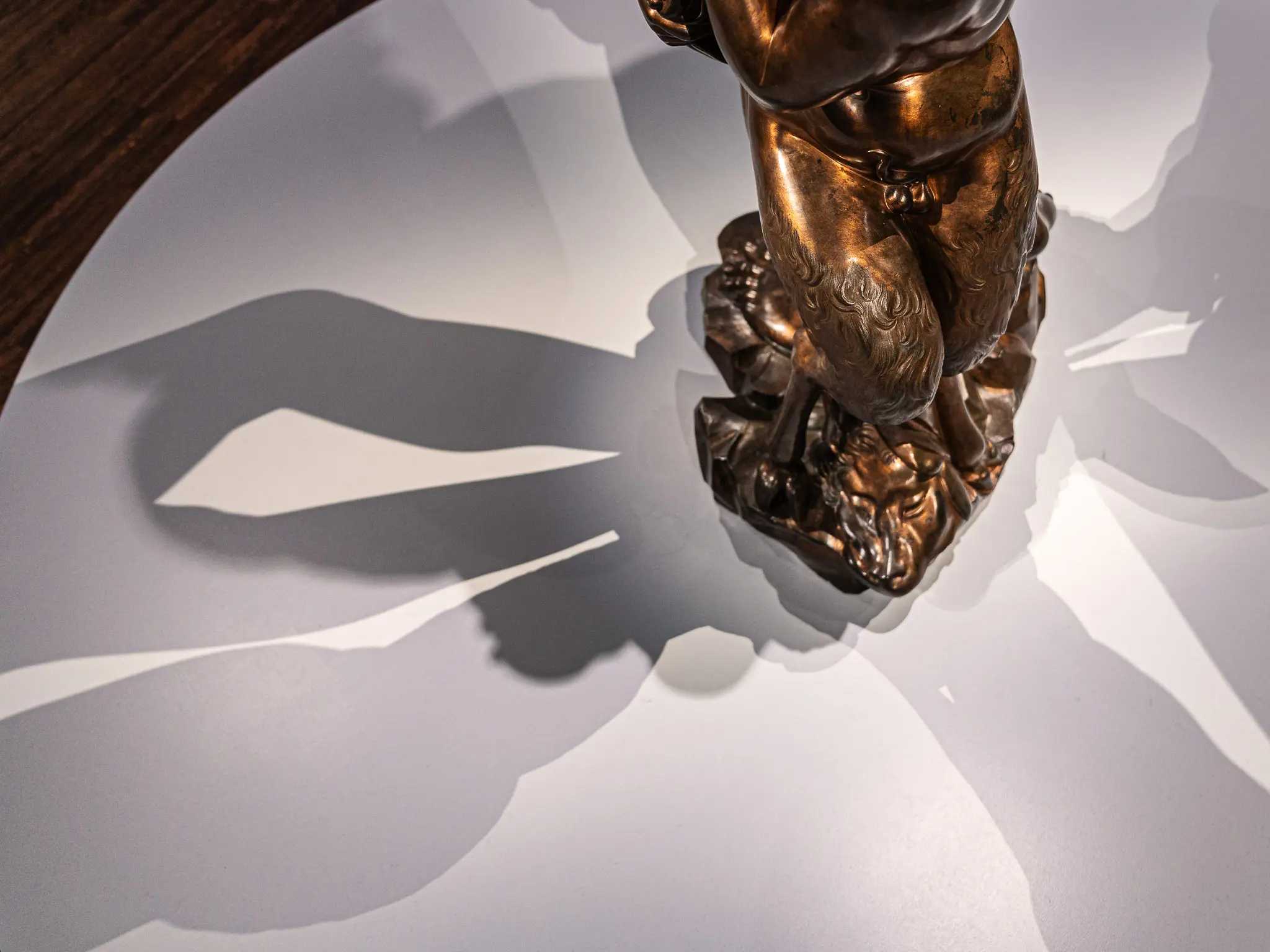 Bronze Sculptural Fragment with Dramatic Shadow Projection