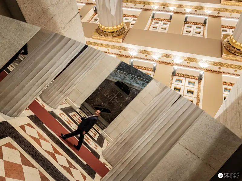 Aerial Perspective of Architectural Interior with Descending Figure on Geometric Stairs