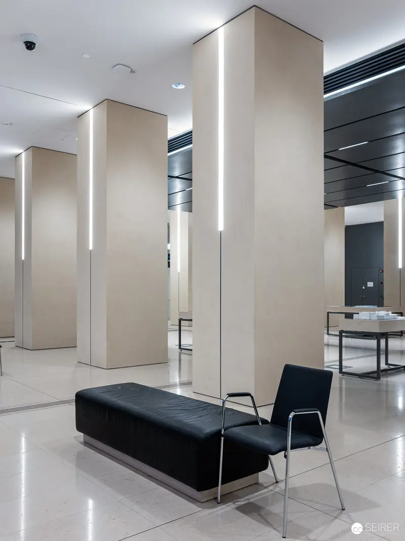 Minimalist Interior with Black Leather Bench and Architectural Columns