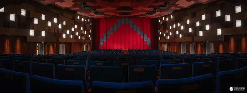Empty Cinema Hall with Red Curtain and Geometric Lighting Design