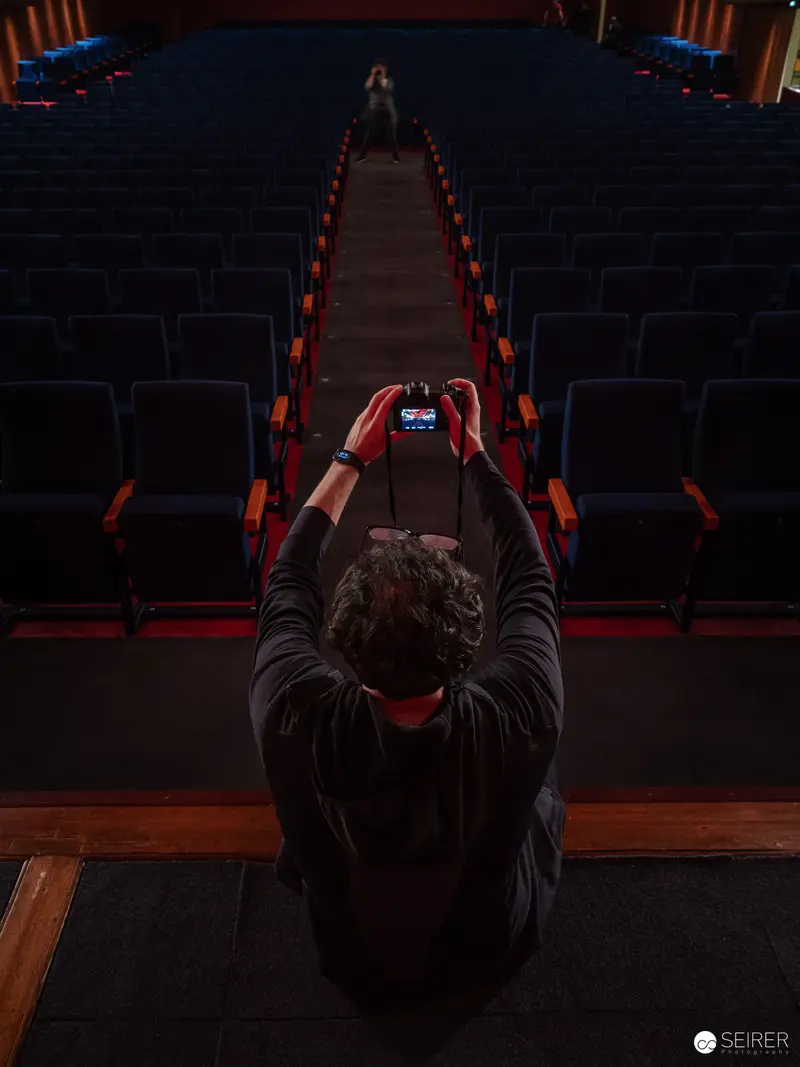 Solitary Spectator Capturing Performance at Film Exhibition Premiere
